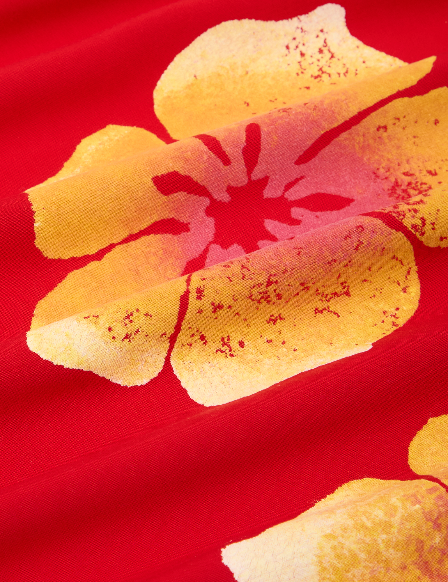 Paintstamped Pantry Button-Up in Mustang Red fabric detail close up. Yellow and red paintstamped flowers.