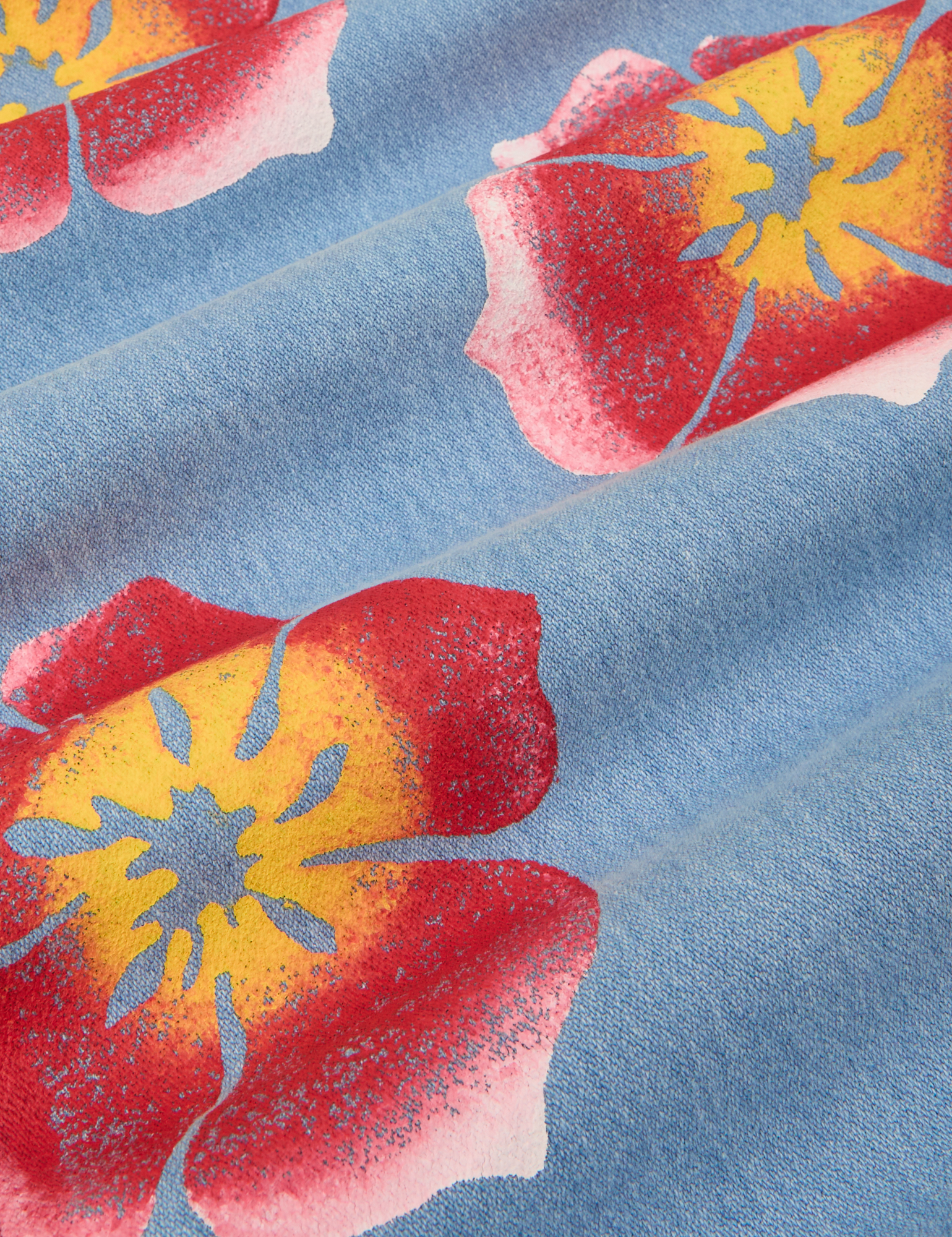 Wide Leg Denim Trousers in Painted Flowers. Light Wash Denim with red and yellow paintstamped flowers. 