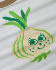 Produce Raglan Tee in Onion close up. Illustrated onion character in off-white and green