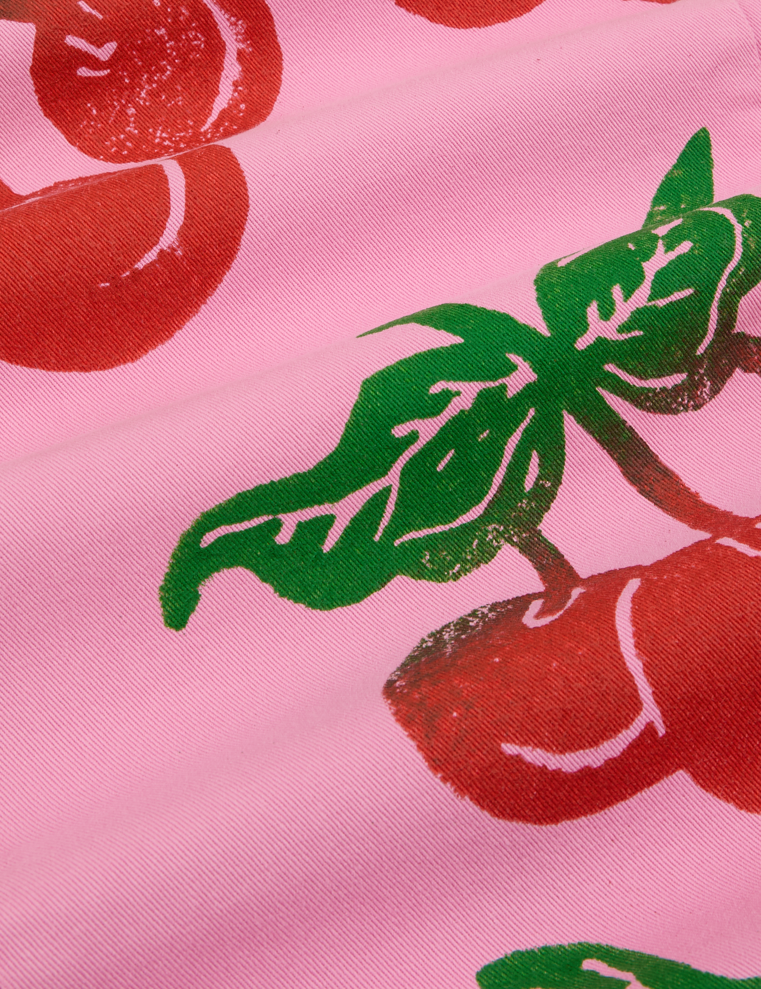 Cherry Paintstamped Work Pants in Bubblegum Pink close up of paintstamped red cherries with green stem