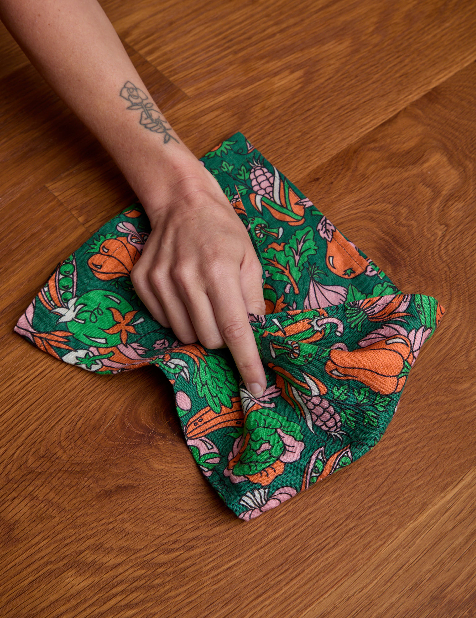 Model using dish towel on surface