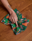 Model using dish towel on surface