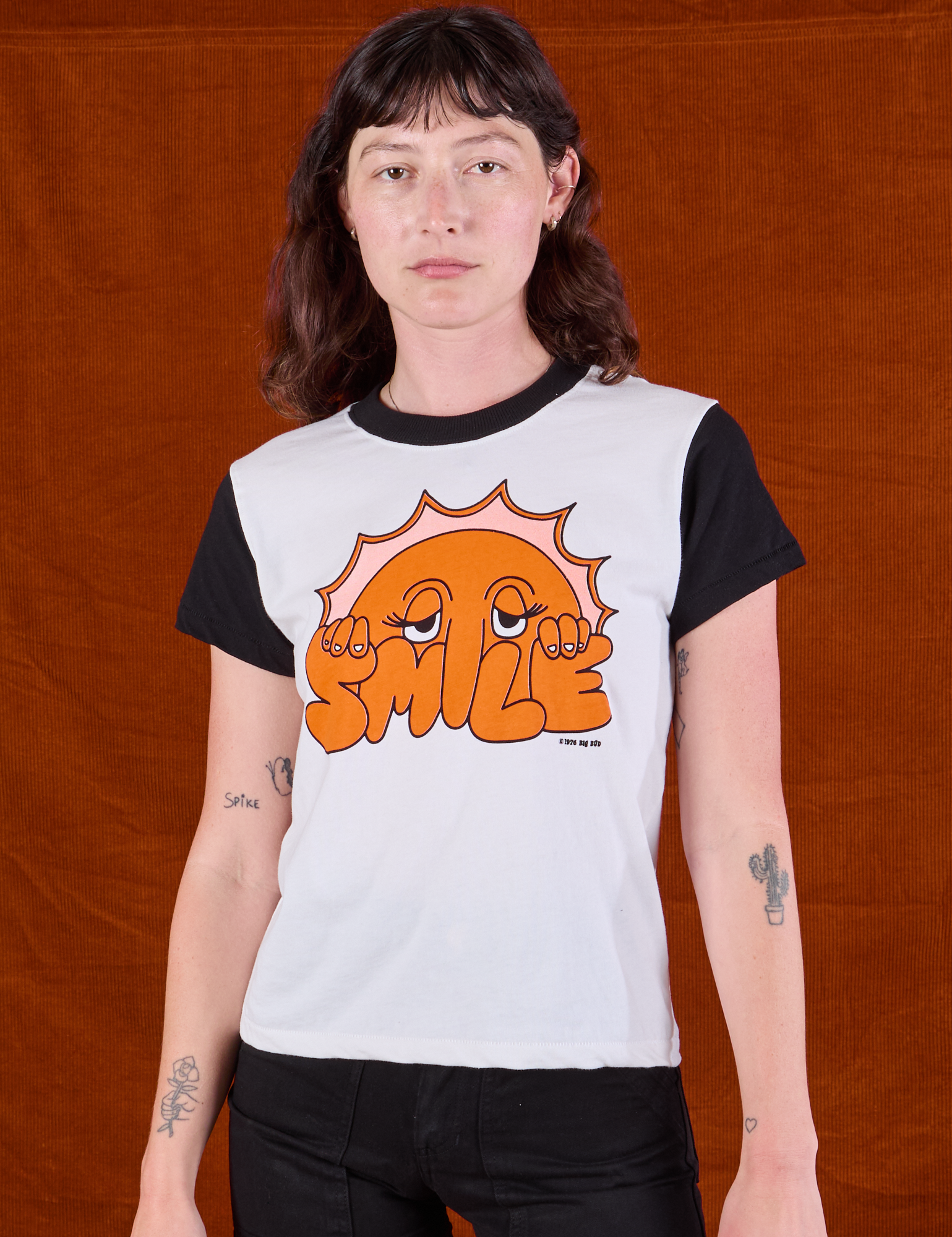 Alex is 5'8" and wearing P Anniversary Tee in Smile