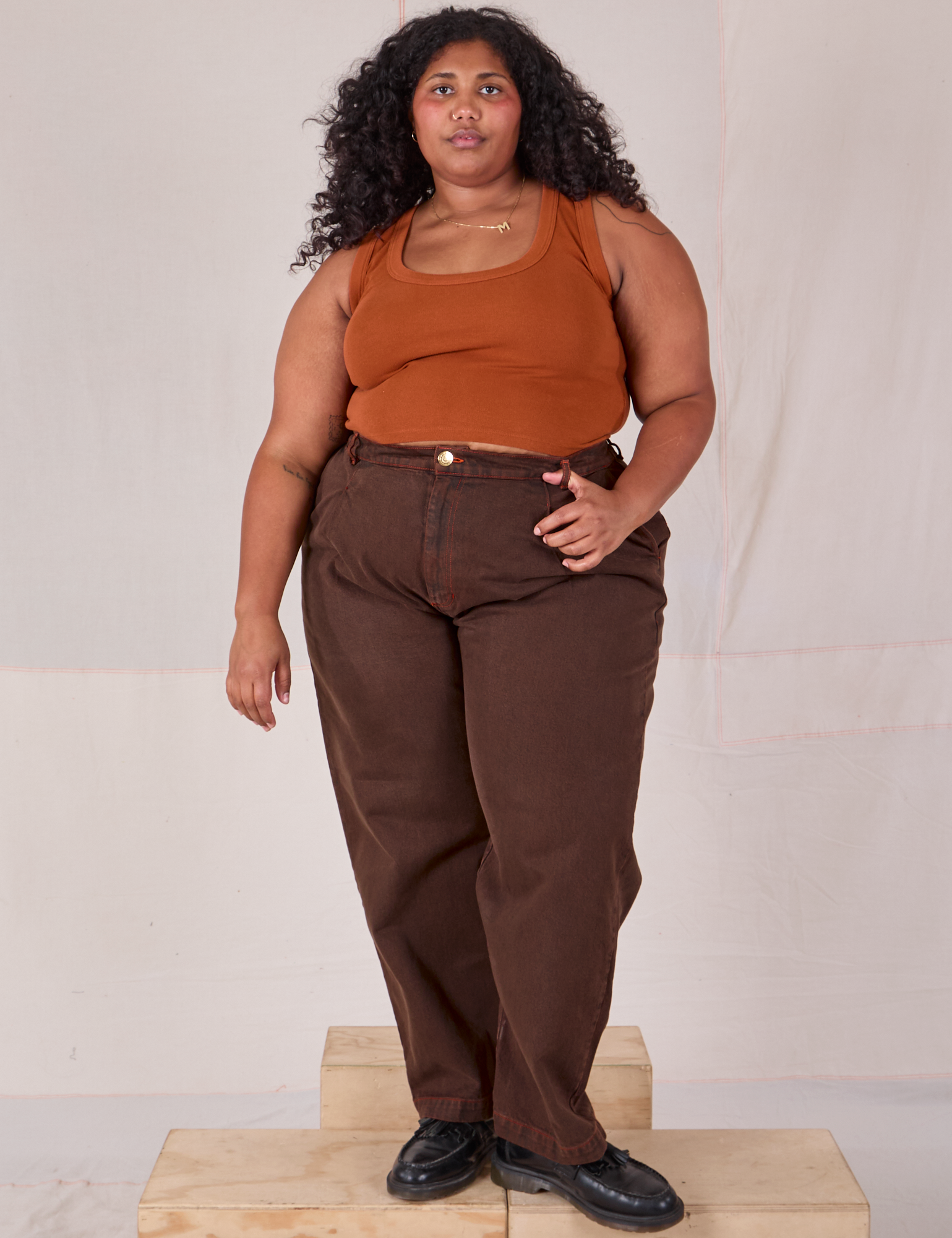 Morgan is wearing Overdyed Denim Trouser in Fudge and burnt terracotta Cropped Tank