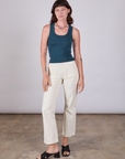 Alex is wearing Tank Top in Lagoon paired with vintage tee off-white Work Pants