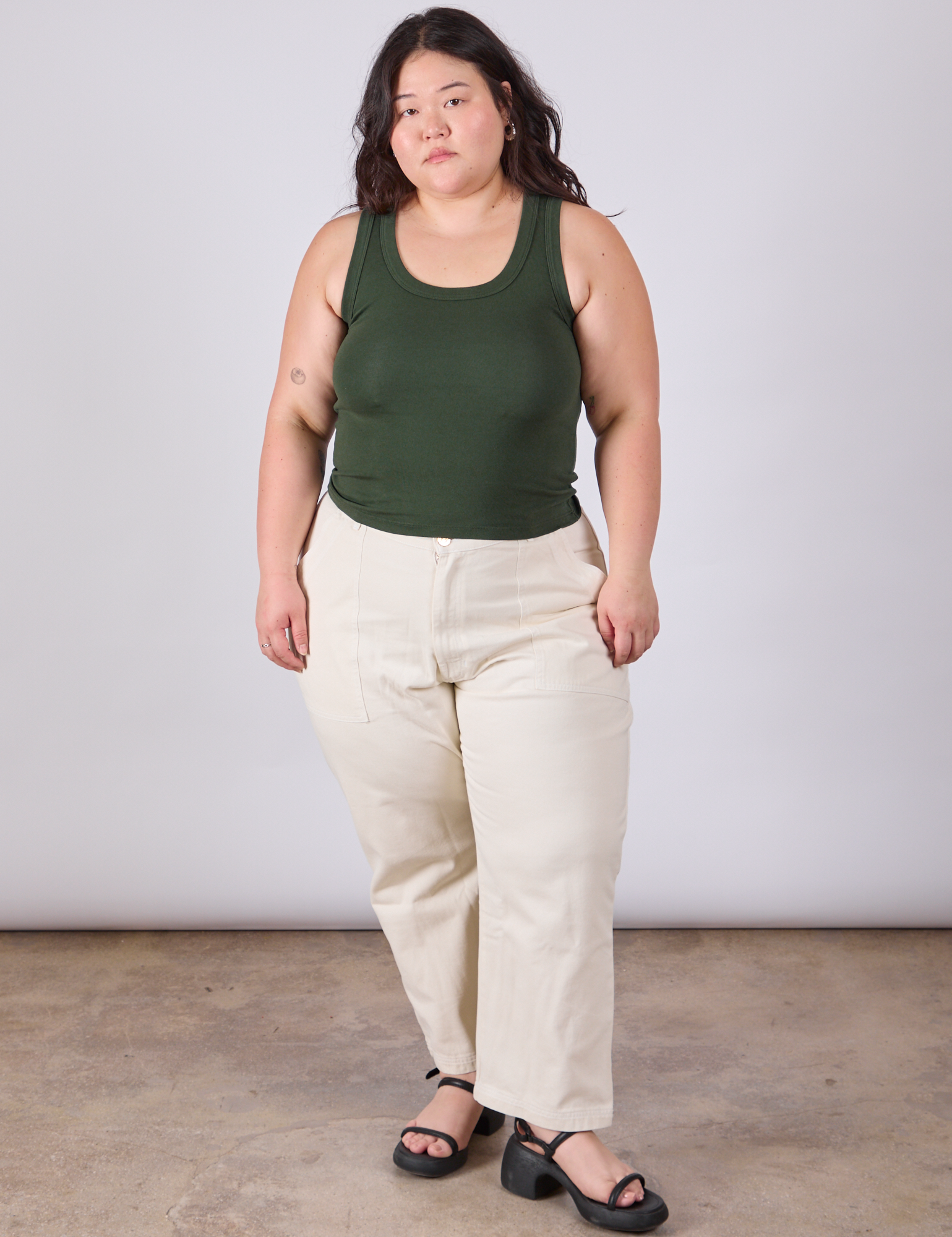 Ashley is wearing Tank Top in Swamp Green paired with vintage tee off-white petite Work Pants