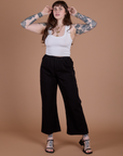Sydney is wearing  Action Pants in Basic Black and Cropped Tank in Vintage Tee White