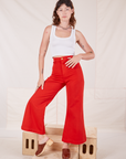 Alex is 5'8" and wearing XXS Bell Bottoms in Mustang Red paired with vintage off-white Cropped Tank Top