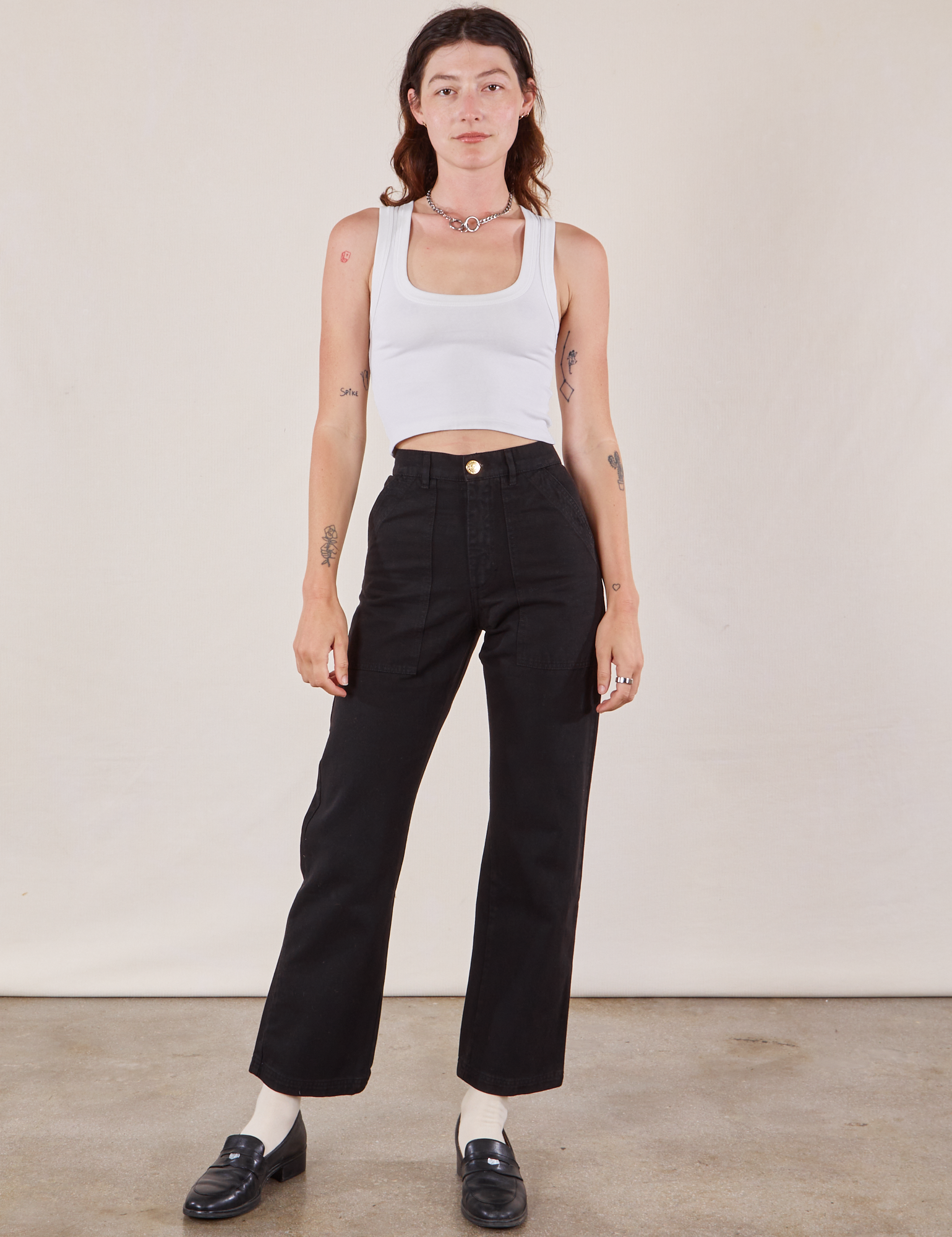 Alex is wearing Work Pants in Black and a Cropped Tank in vintage tee off-white