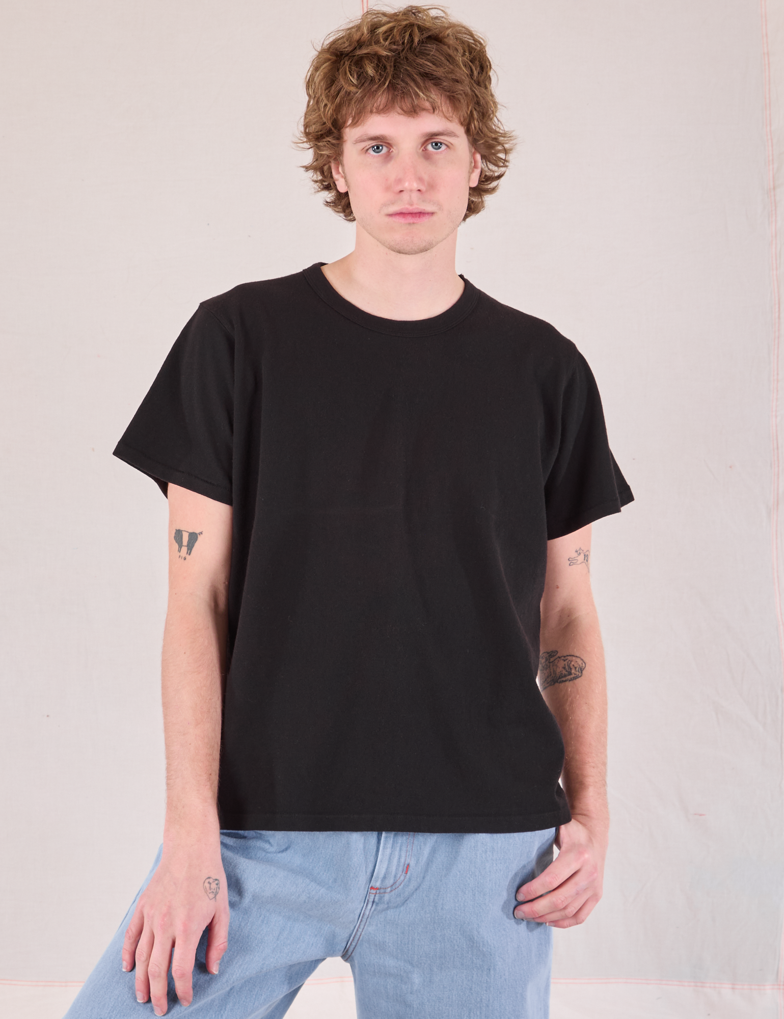 Quinn is 6'3" and wearing S Burly Tee in Basic Black