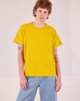 Quinn is 6'3" and wearing S Burly Tee in Golden Yellow