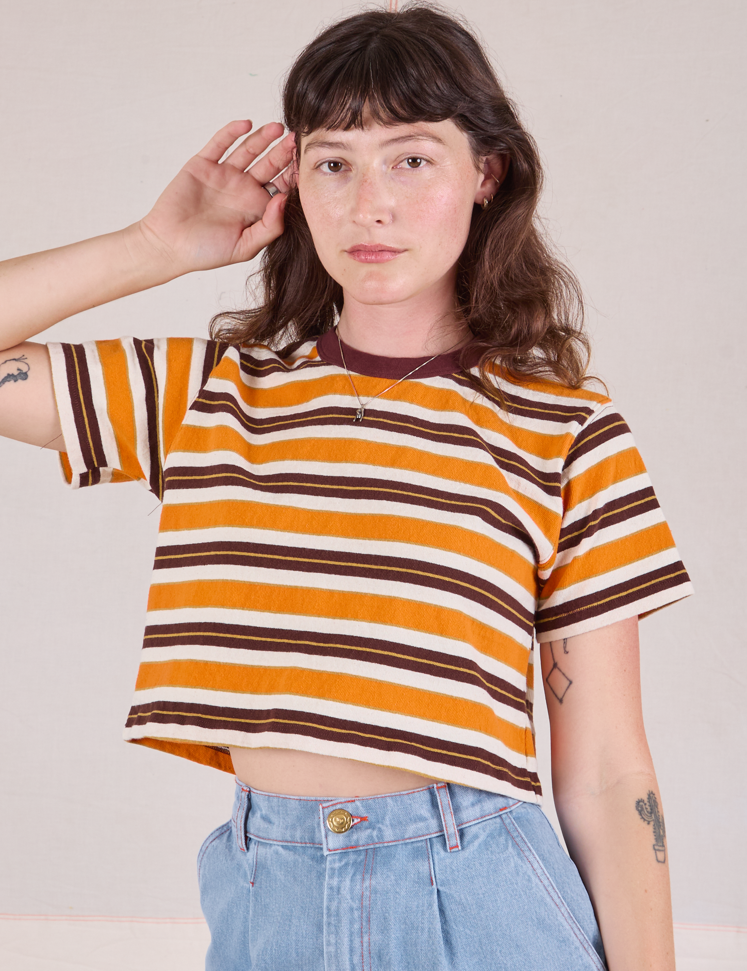 Alex is wearing Striped Crop Burly Tee in Orange & Brown