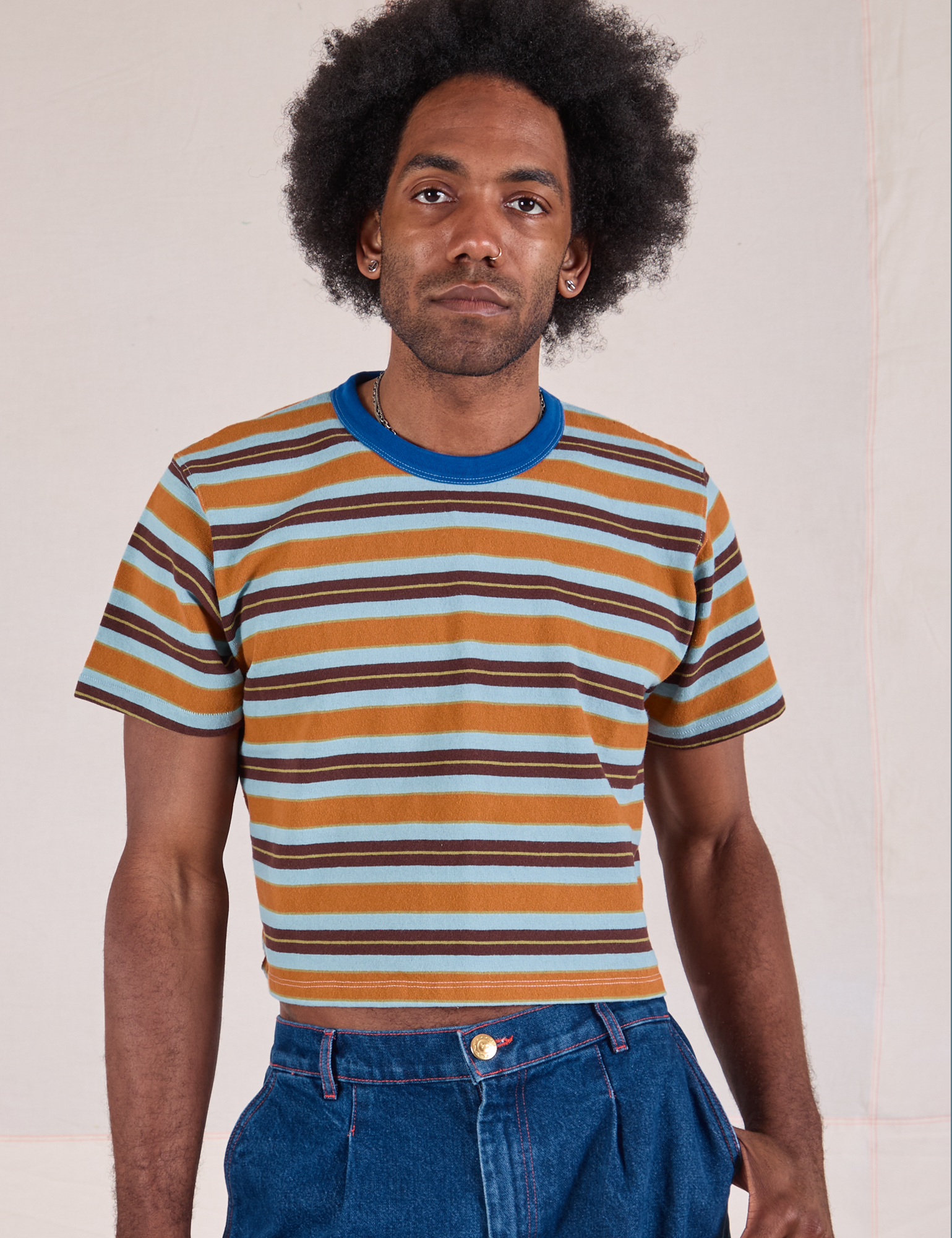 Jerrod is 6'3" and wearing S Striped Crop Burly Tee in Baby Blue Overdye 