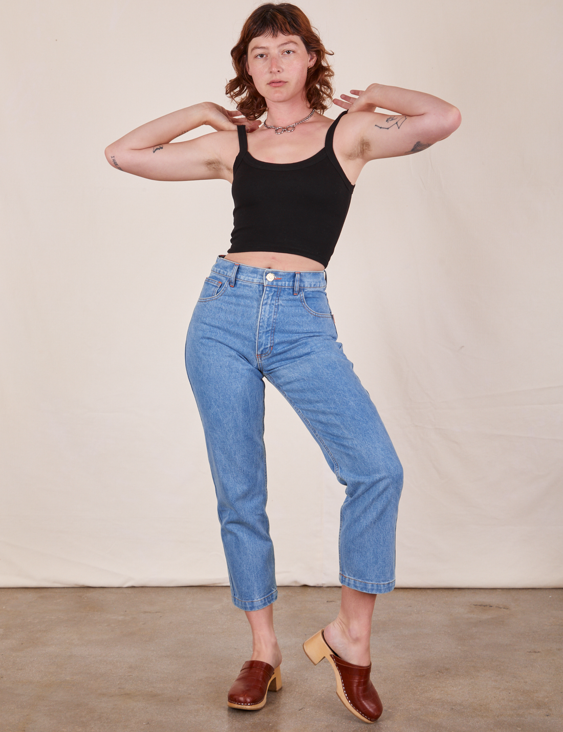 Alex is wearing P Cropped Cami in Basic Black worn with light wash Frontier Jeans