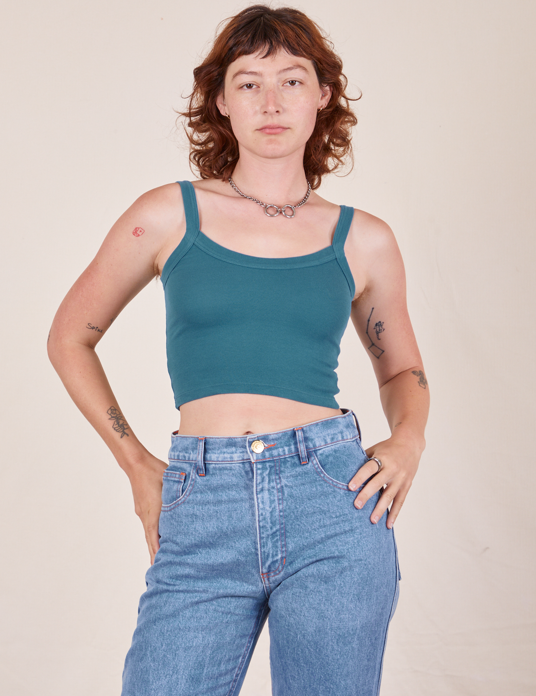 Alex is wearing Cropped Cami in Marine Blue and light wash Frontier Jeans