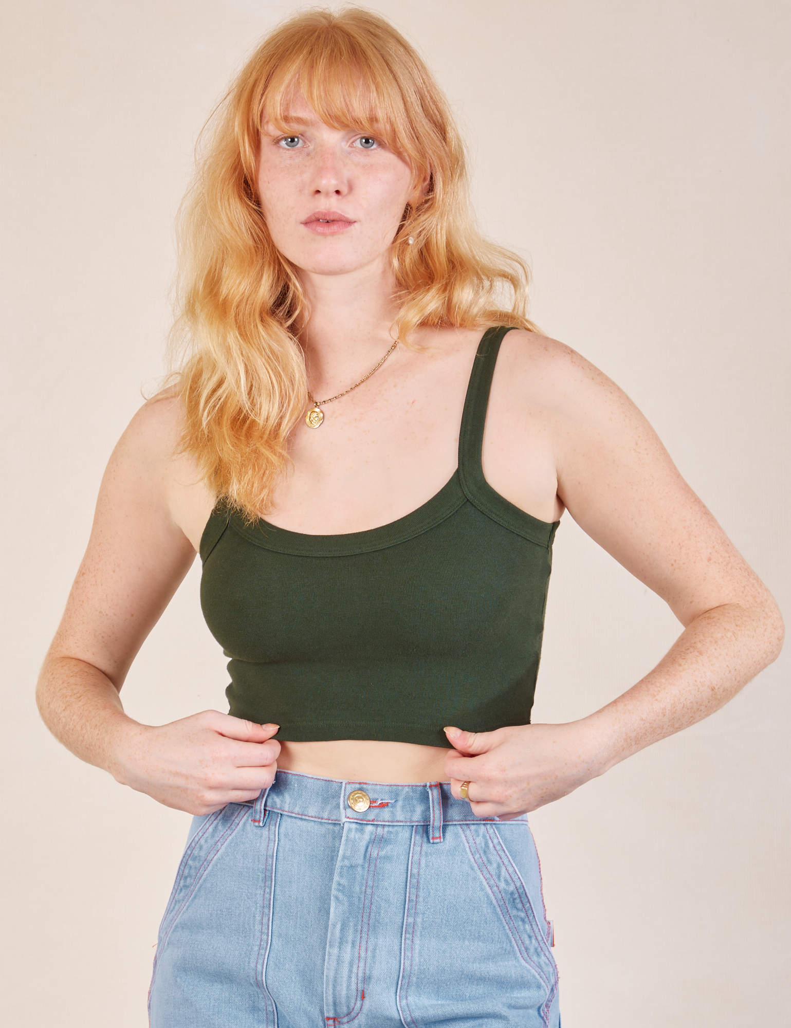 Margaret is wearing Cropped Cami in Swamp Green