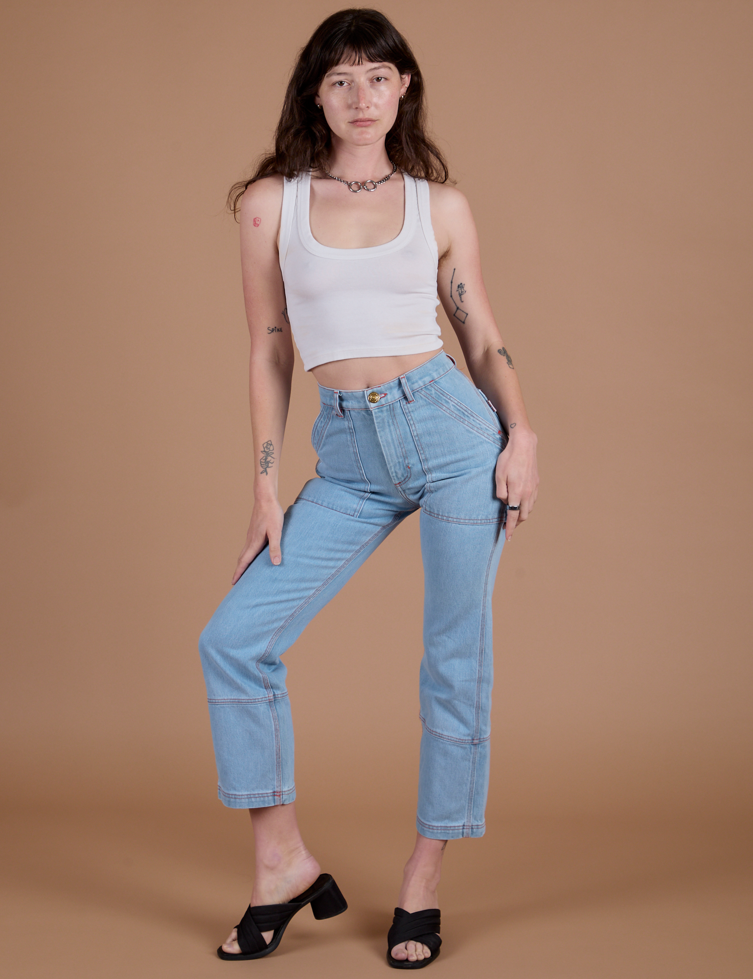 Alex is wearing Carpenter Jeans in Light Wash and Cropped Tank in Vintage Tee Off-White