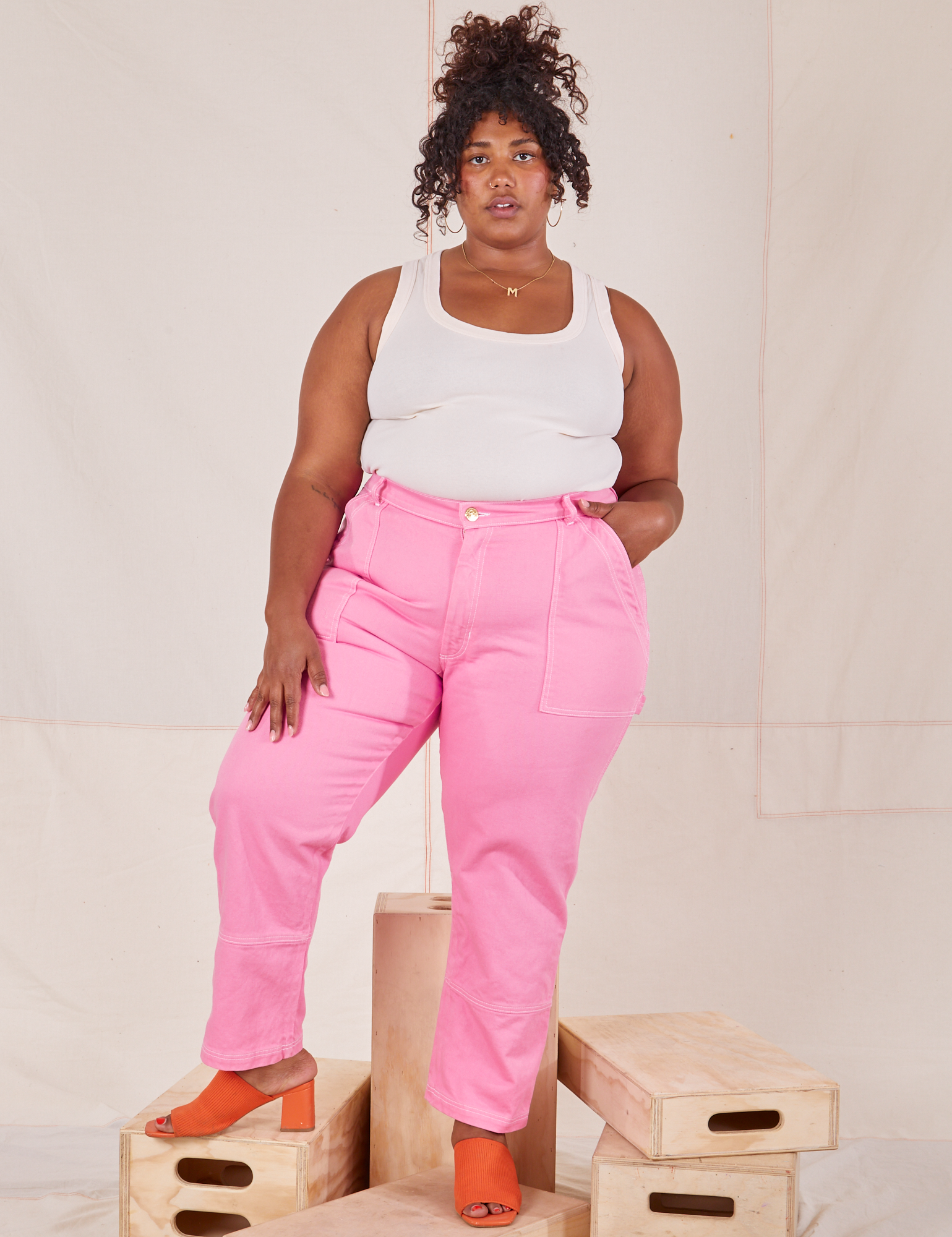 Morgan is wearing Carpenter Jeans in Bubblegum Pink and vintage off-white Tank Top