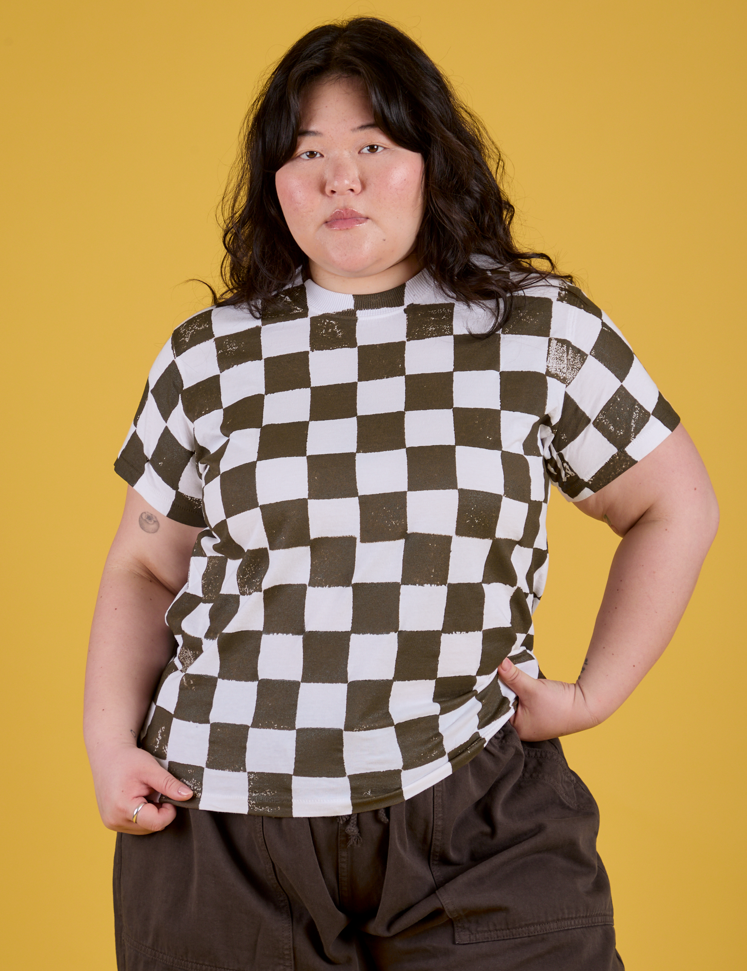 Ashley is 5'7" and wearing L Checker Organic Tee in Espresso Brown