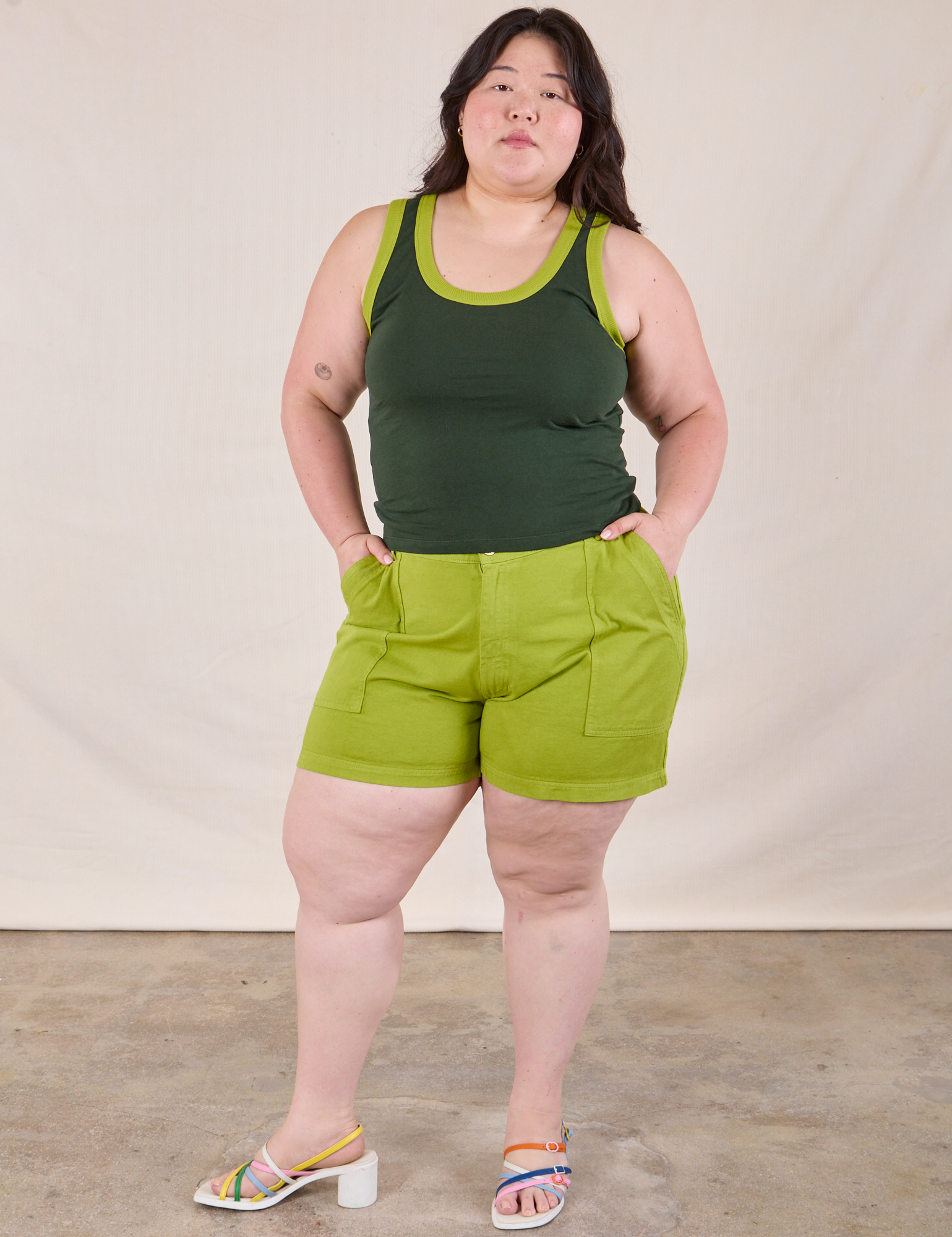 Ashley is wearing Colorblock Cropped Tank in Swamp Green and gross green Work Shorts