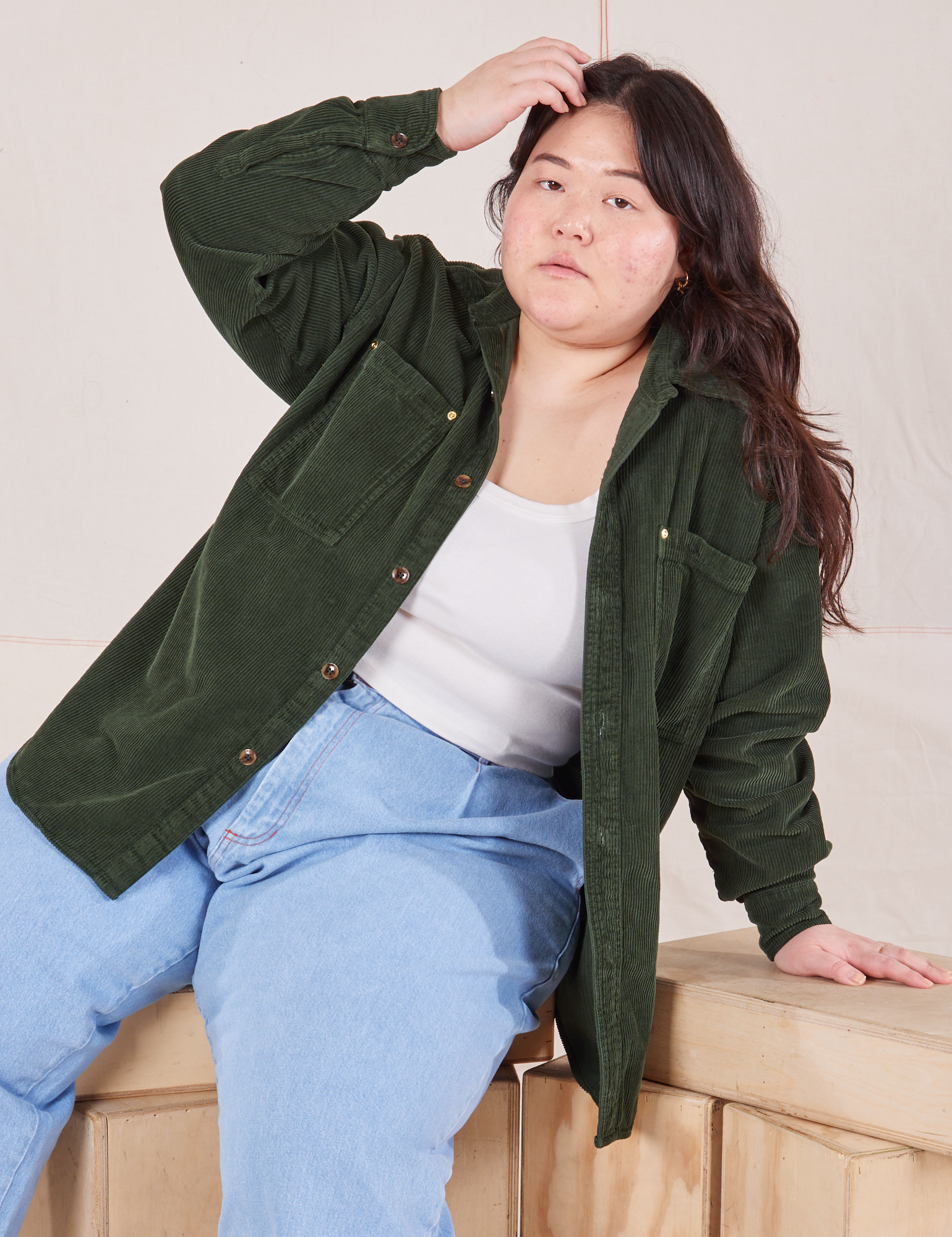 Ashley is wearing Corduroy Overshirt in Swamp Green and light wash Denim Trouser Jeans