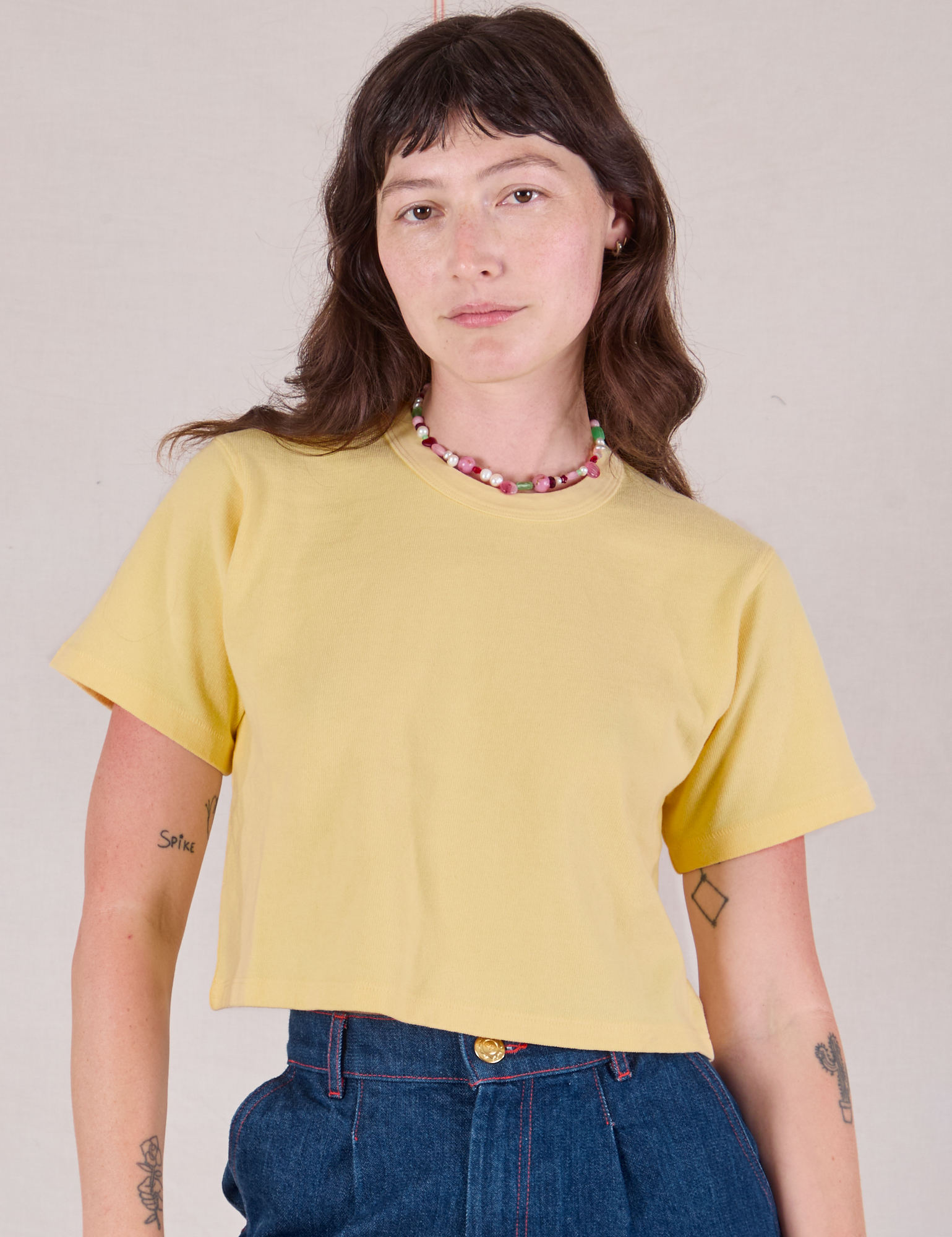 Alex is wearing Cropped Burly Tee in Butter Yellow