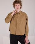 Quinn is wearing a buttoned up Cropped Overshirt in Desert Brown