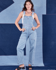 Alex is wearing Indigo Denim Original Overalls in Light Wash