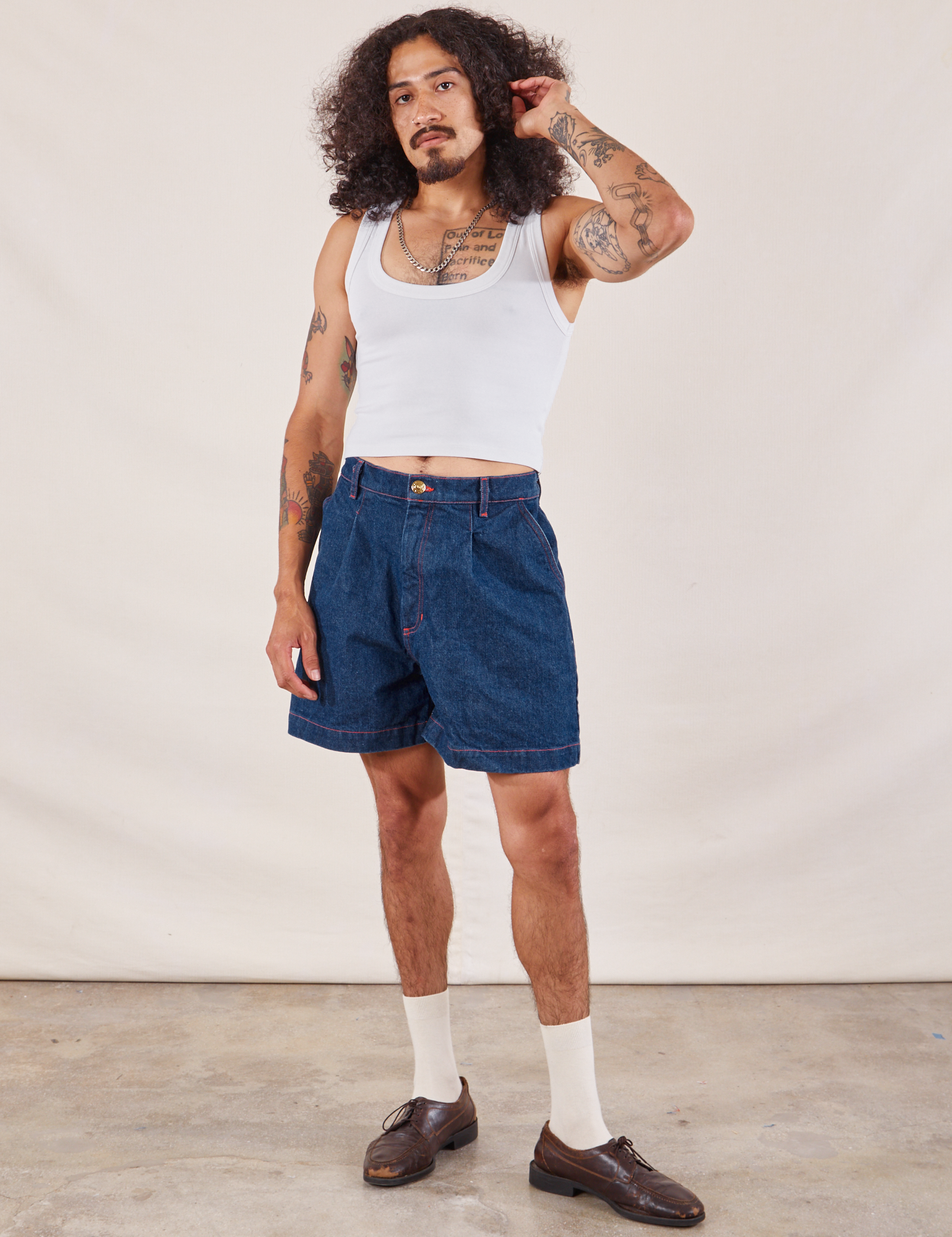 Jesse is wearing Denim Trouser Shorts in Dark Wash paired with Cropped Tank in vintage tee off-white