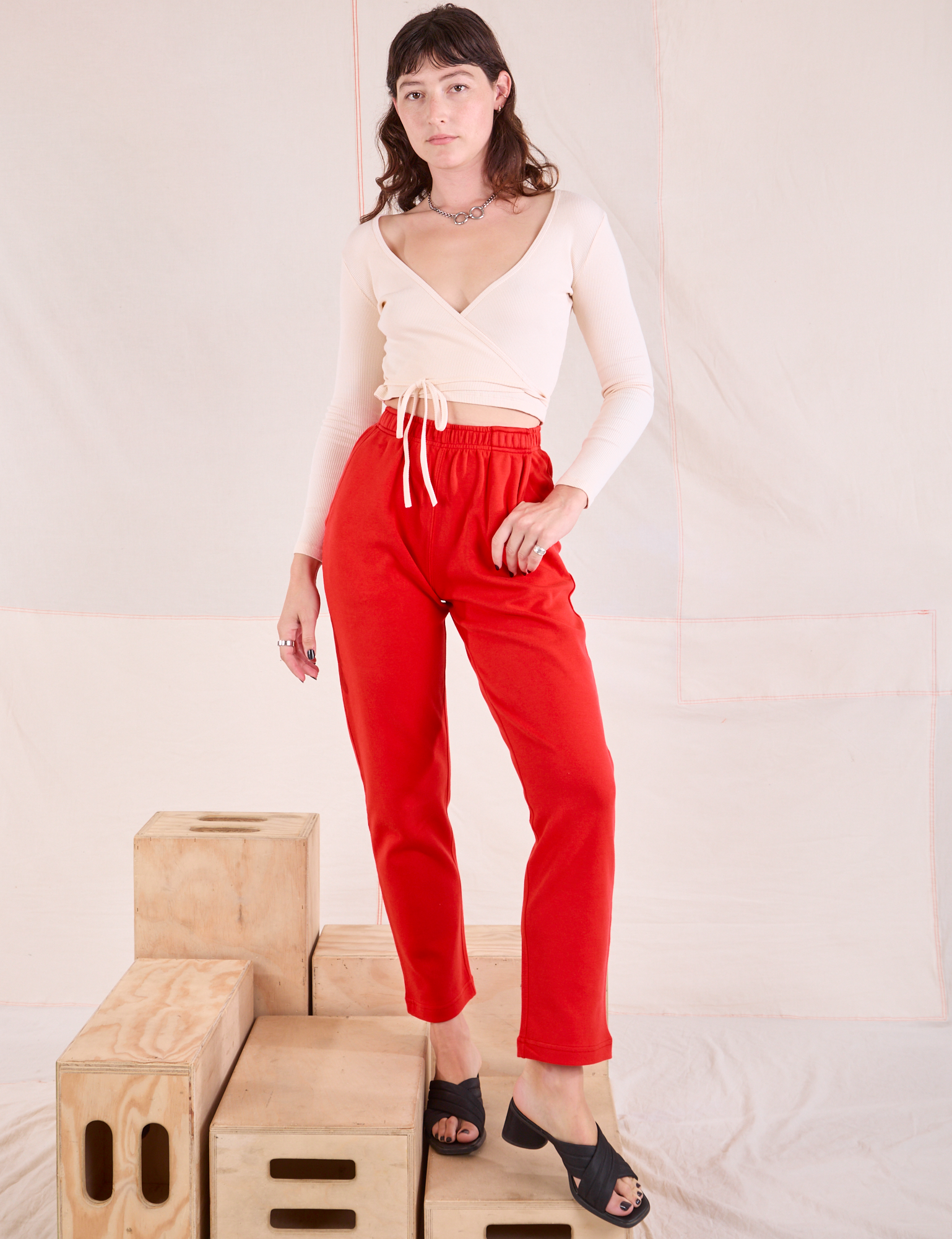 Alex is 5'8" and wearing P Easy Pants in Mustang Red paired with a vintage tee off-white Wrap Top