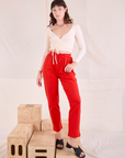 Alex is 5'8" and wearing P Easy Pants in Mustang Red paired with a vintage tee off-white Wrap Top