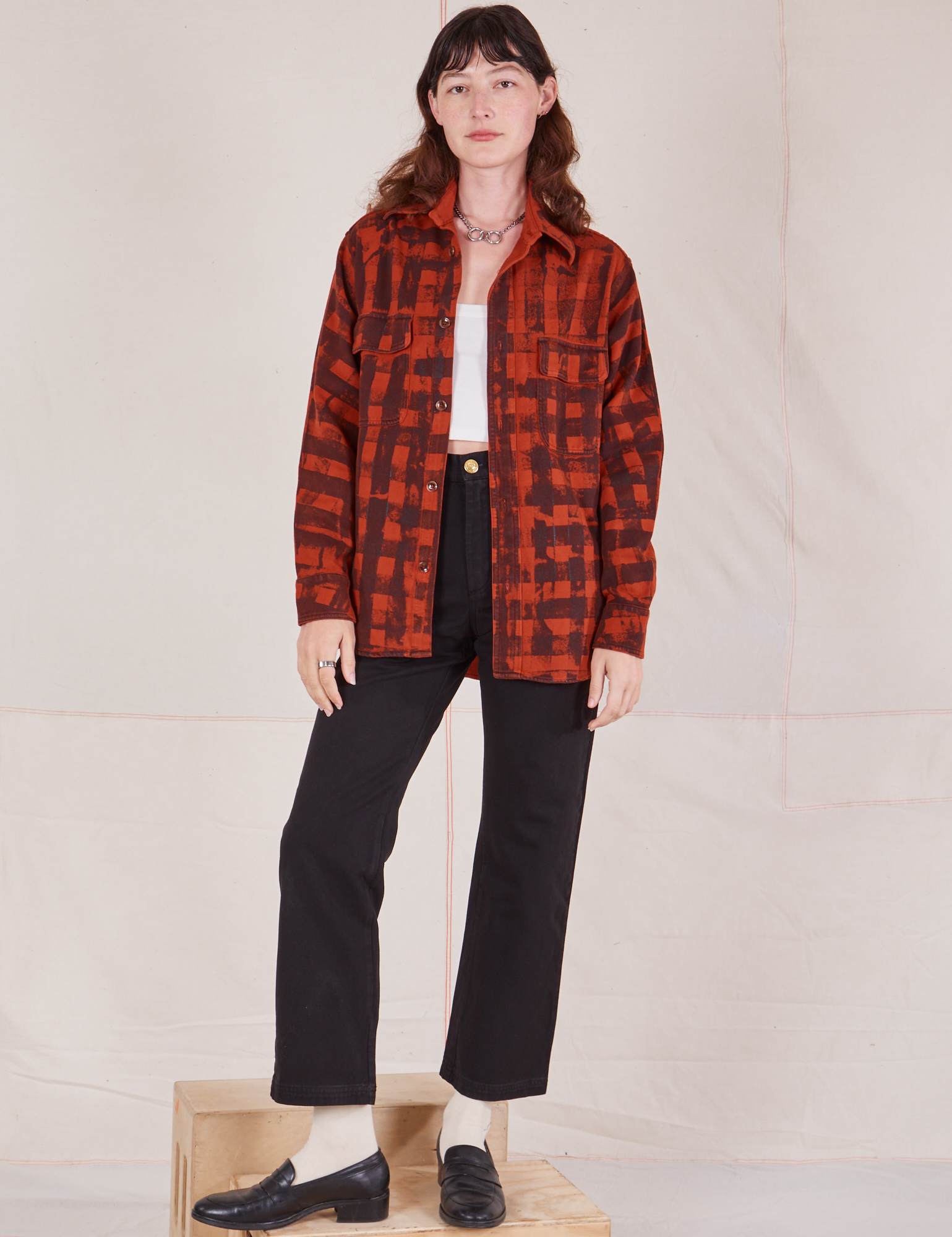 Alex is 5'8" and wearing P Plaid Flannel Overshirt in Paprika paired with black Work Pants