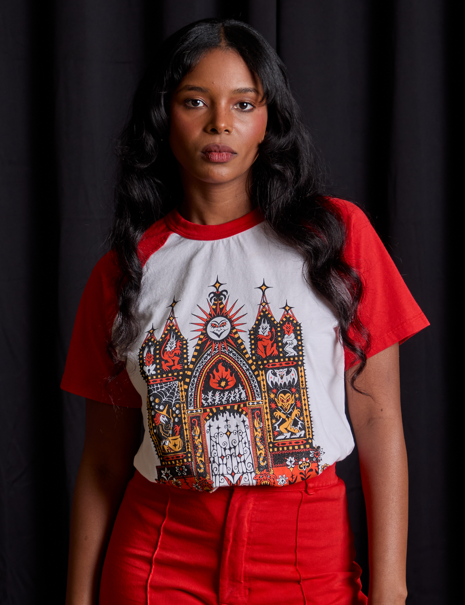 Kandia is 5'3" and wearing XXS Short Sleeve Raglan Tee in Gates of Hell