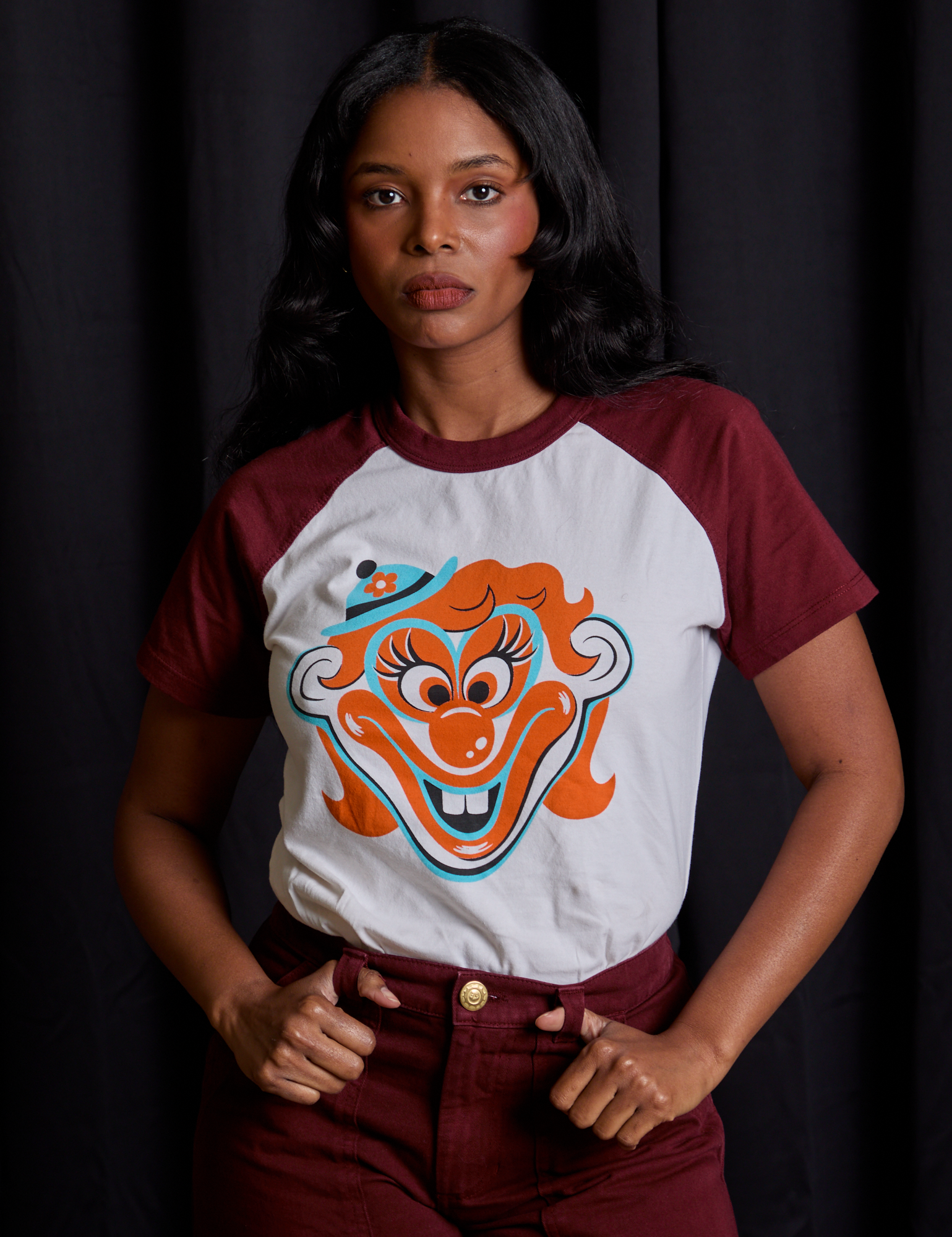 Kandia is 5'3" and wearing XXS Raglan Tee in Clown