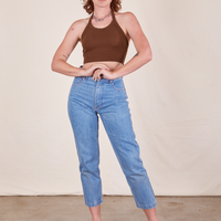 Alex is wearing Halter Top in Fudgesicle Brown and light wash Frontier Jeans 