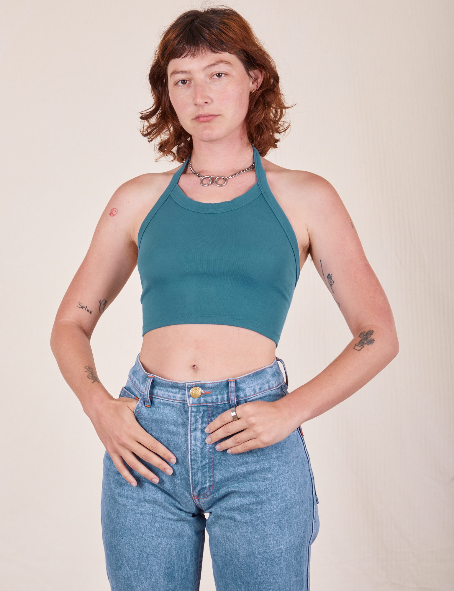 Alex is wearing Halter Top in Marine Blue and light wash Frontier Jeans