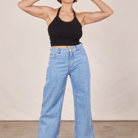 Tiara is wearing Halter Top in Basic Black and light wash Sailor Jeans