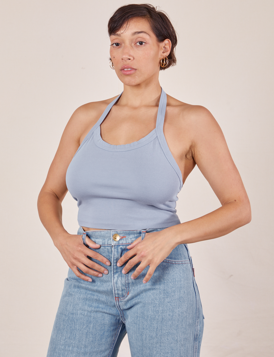 Tiara is wearing Halter Top in Periwinkle and light wash Sailor Jeans