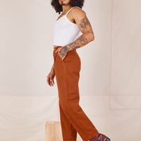 Side view of Heavyweight Trousers in Burnt Terracotta and vintage off-white Cropped Cami worn by Jesse