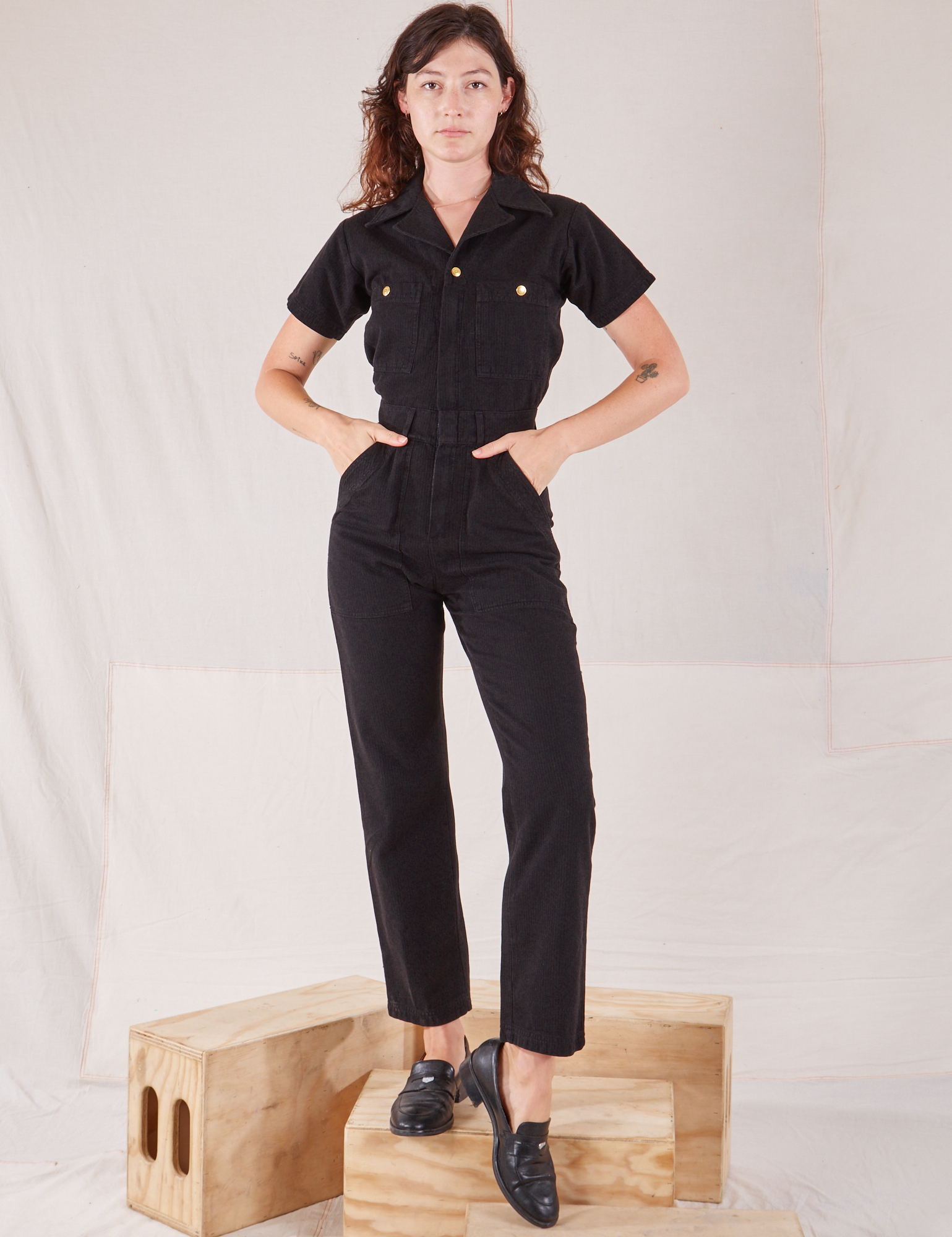 Alex is 5&#39;8&quot; and wearing XXS Heritage Short Sleeve Jumpsuit in Basic Black