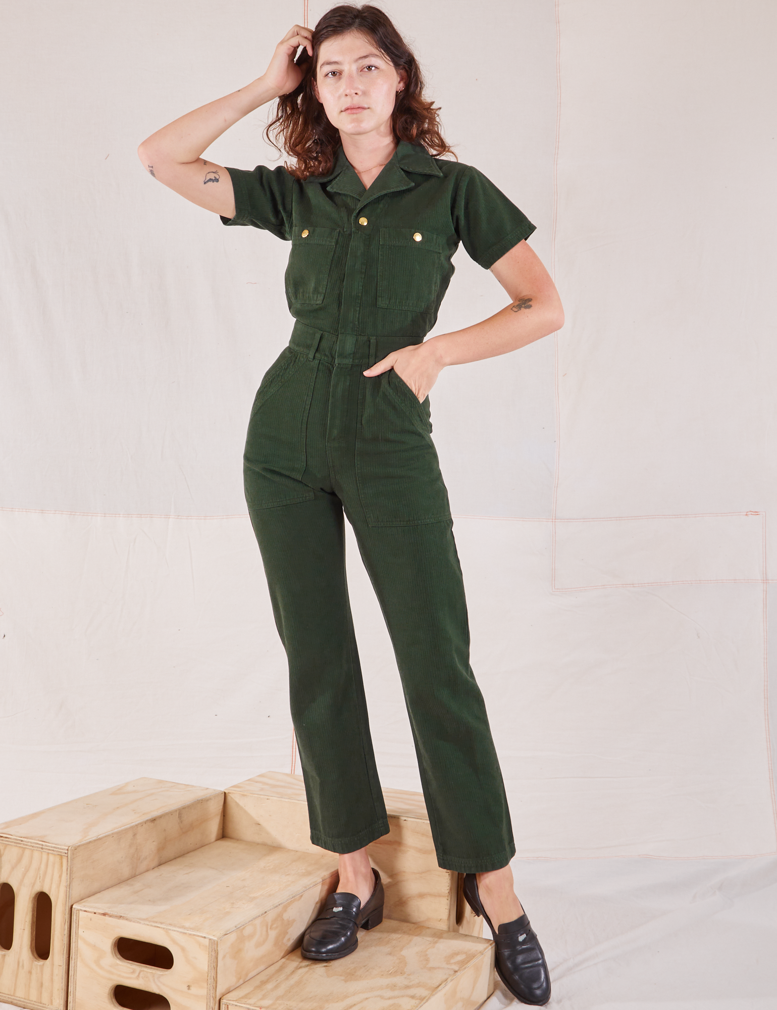 Alex is wearing Heritage Short Sleeve Jumpsuit in Swamp Green