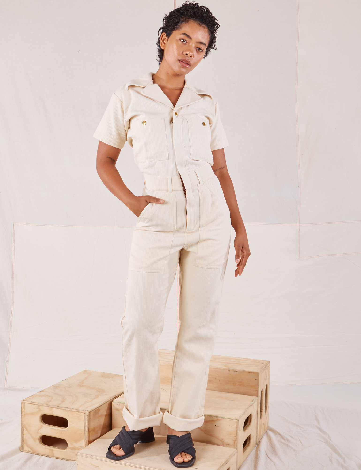 Mika is 5’1” and wearing XXS Heritage Short Sleeve Jumpsuit in Natural