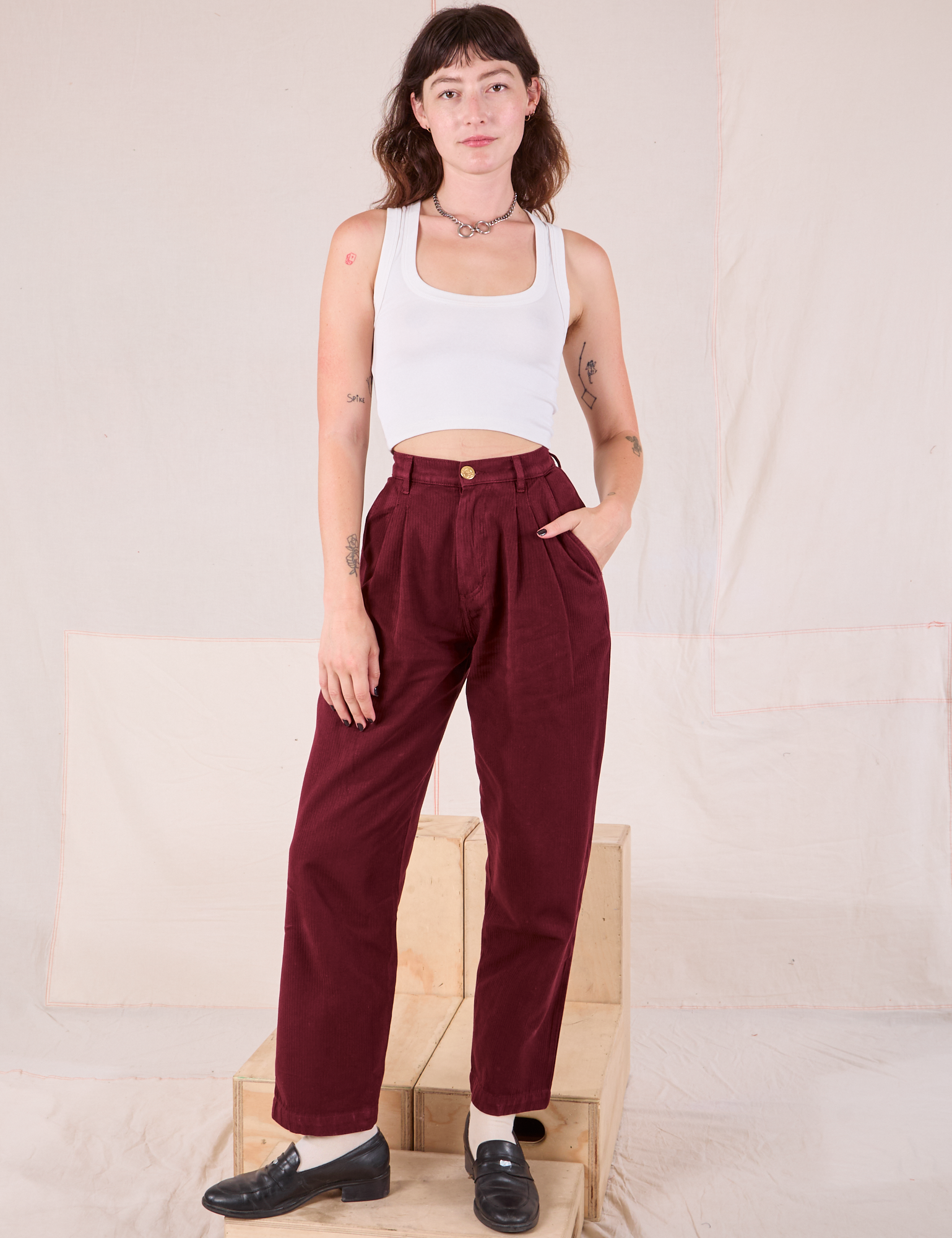 Alex is wearing Heritage Trousers in Red Wine and Cropped Tank in Vintage Tee Off-White