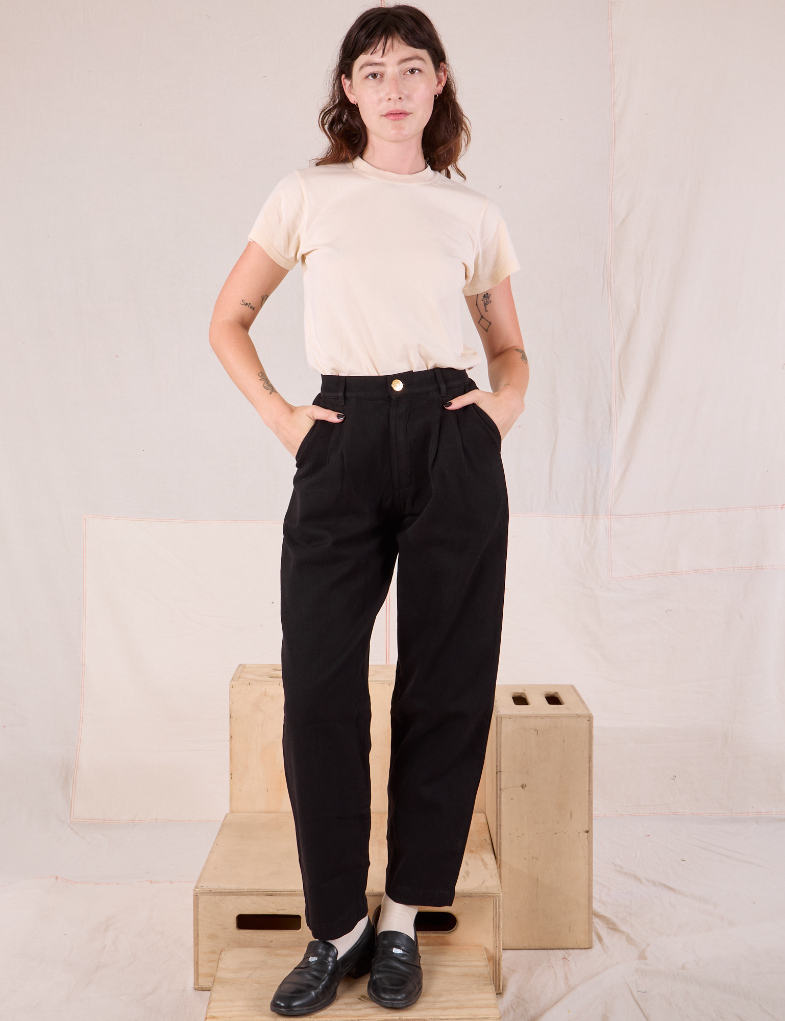 Alex is 5’8” and wearing XXS Heritage Trousers in Basic Black paired with Organic Vintage Tee in vintage tee off-white