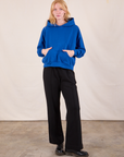 Margaret is wearing Oversized Hoodie in Royal Blue and black Western Pants