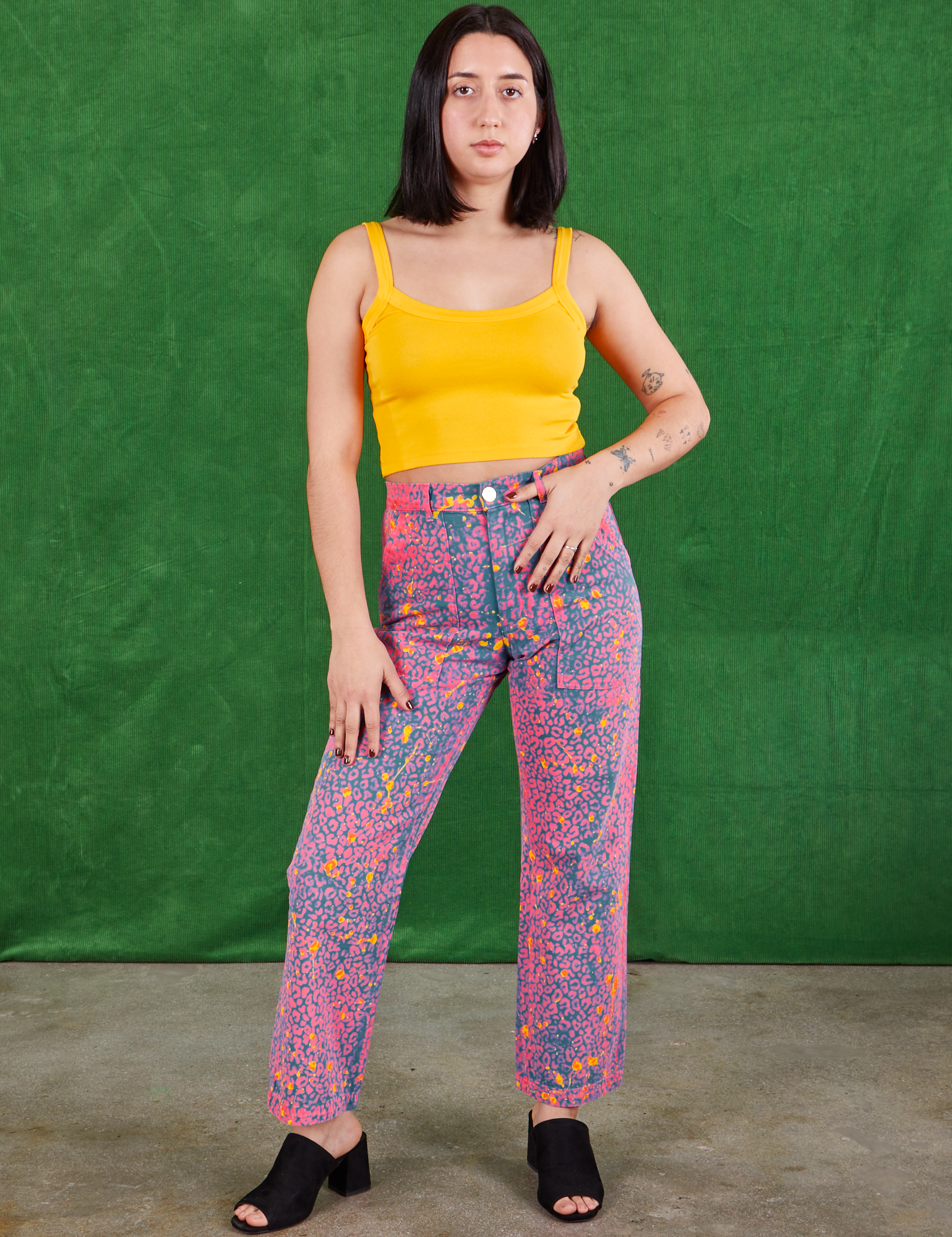 Betty is 5'7" and wearing XS Work Pants in Electric Leopard and sunshine yellow Cami