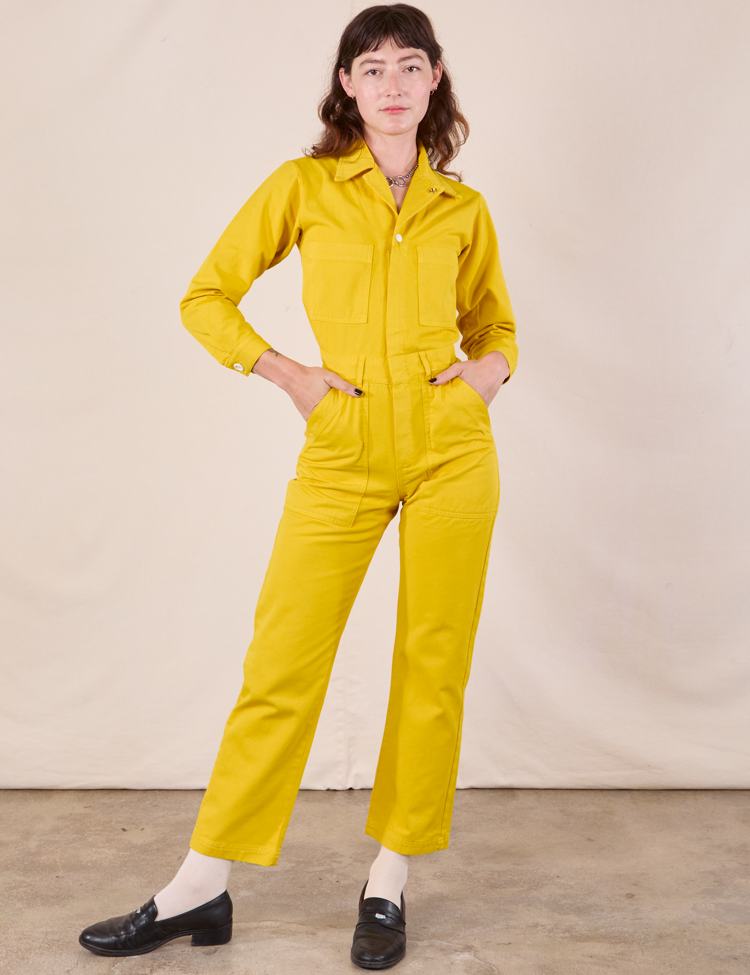 Alex is 5'8" and wearing XXS Long Sleeve Jumpsuit in Golden Yellow