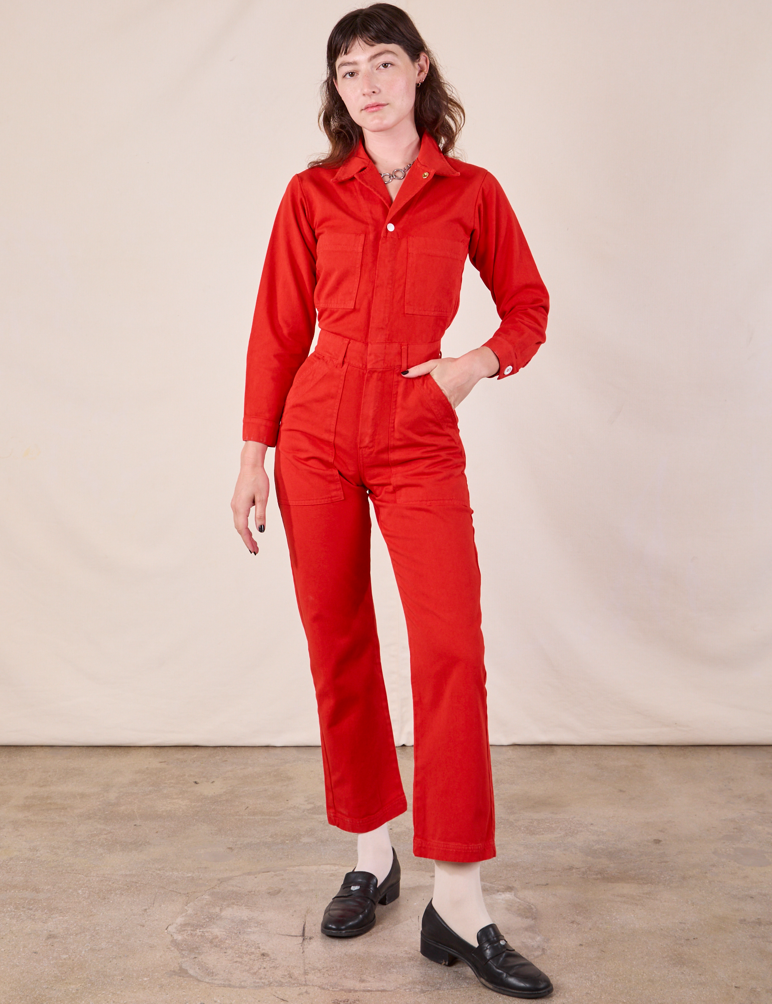 Alex is wearing Long Sleeve Jumpsuit in Mustang Red