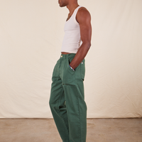 Jerrod is 6'3" and wearing Long S Work Pants in Dark Emerald Green paired with vintage off-white Tank Top