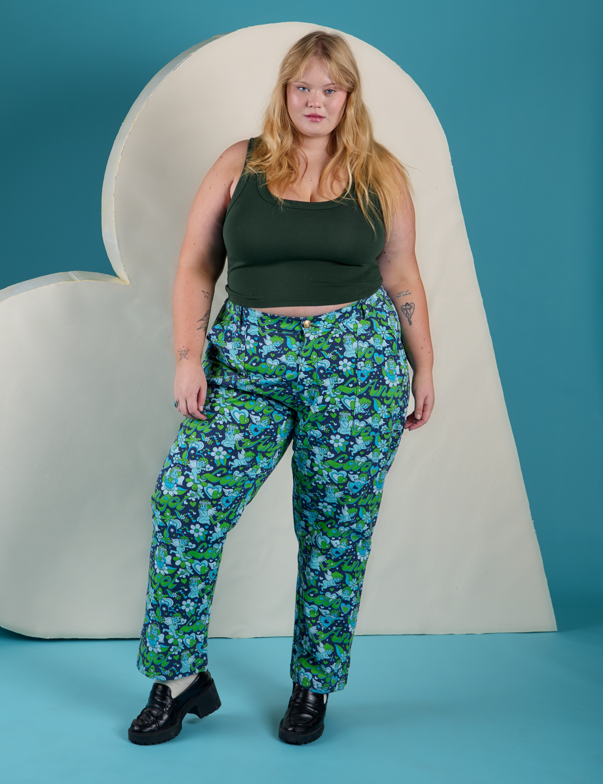 Juliet is wearing Work Pants in Angel Print paired with swamp green Cropped Tank